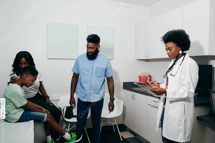 Pediatrician with patients in her office