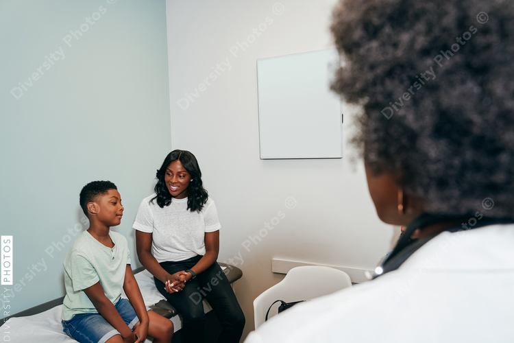 African American Pediatrician with patients in her office