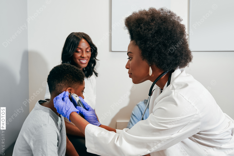African American Pediatrician examining patient