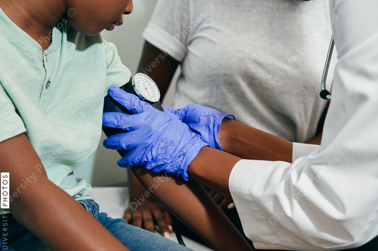 Black Pediatrician examining patient