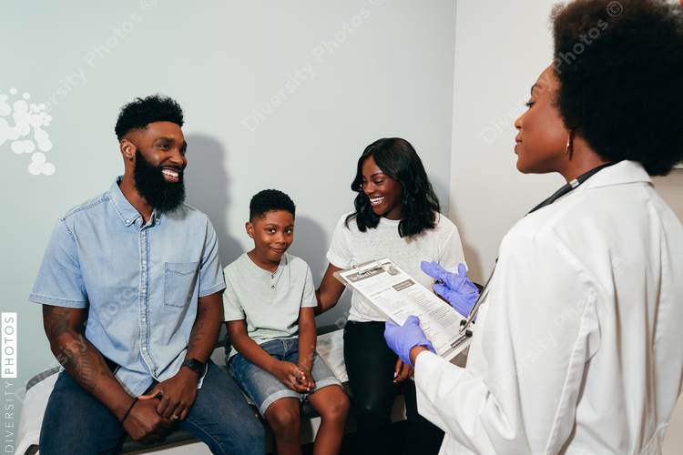Black Pediatrician with patients in her office, examine room