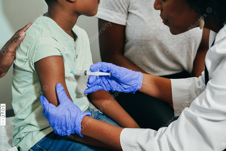 Pediatrician vaccinating her patient
