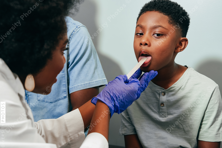 Black Pediatrician¬†examining patient