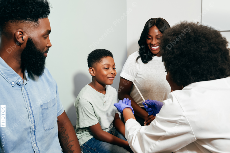Woman Pediatrician¬†examining patient with family