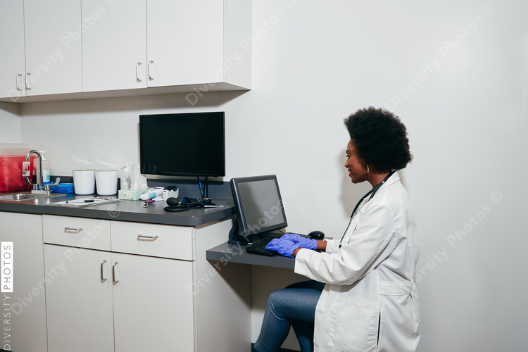 Pediatrician using computer in her office