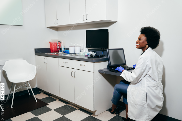 African American Pediatrician¬†using computer in her office