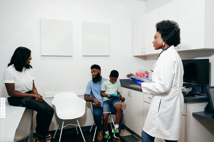 Black Padiatrician¬†with patients in her office