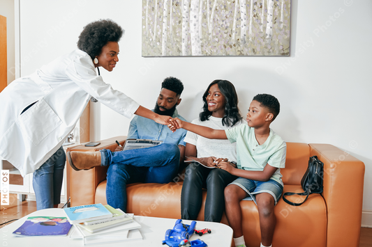Black Family meeting doctor in clinic