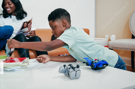 African American Boy playing with toys in waiting room