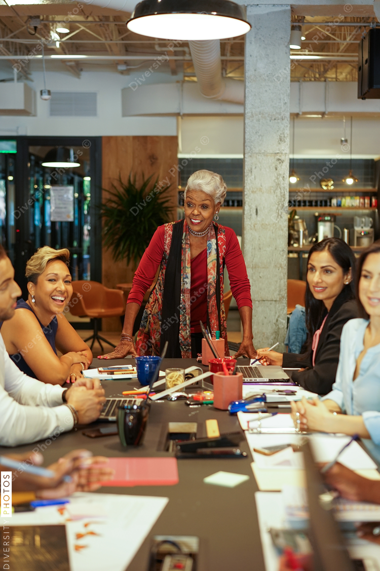 Senior businesswoman in office meeting with colleagues 