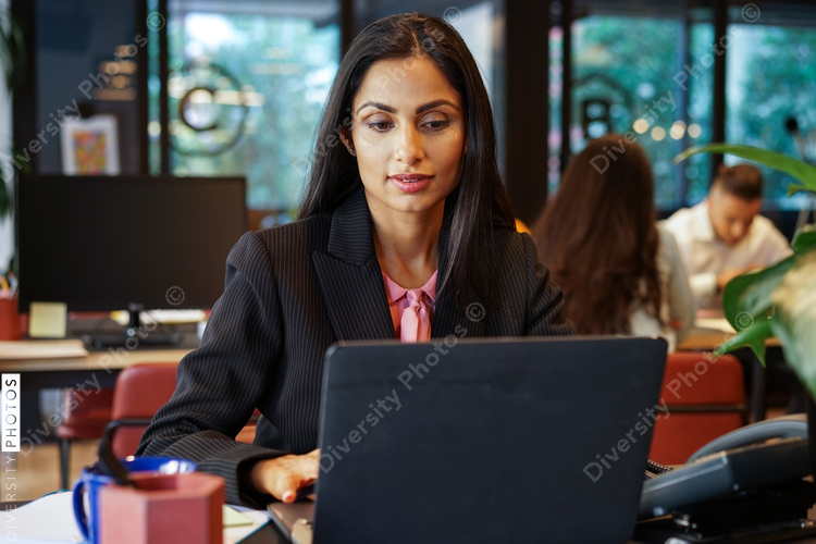 Businesswoman using laptop in office