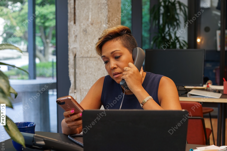 Woman using phone in office