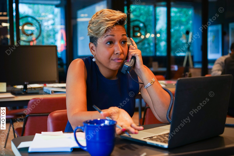 Businesswoman talking on telephone in office