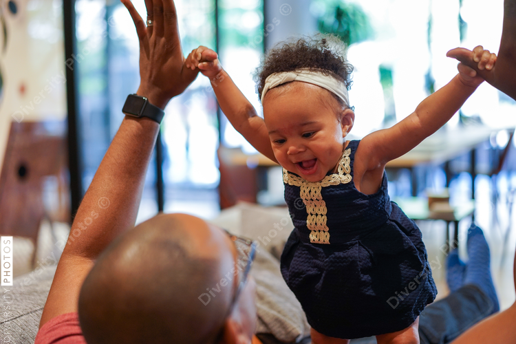 Father playing with a daughter at home