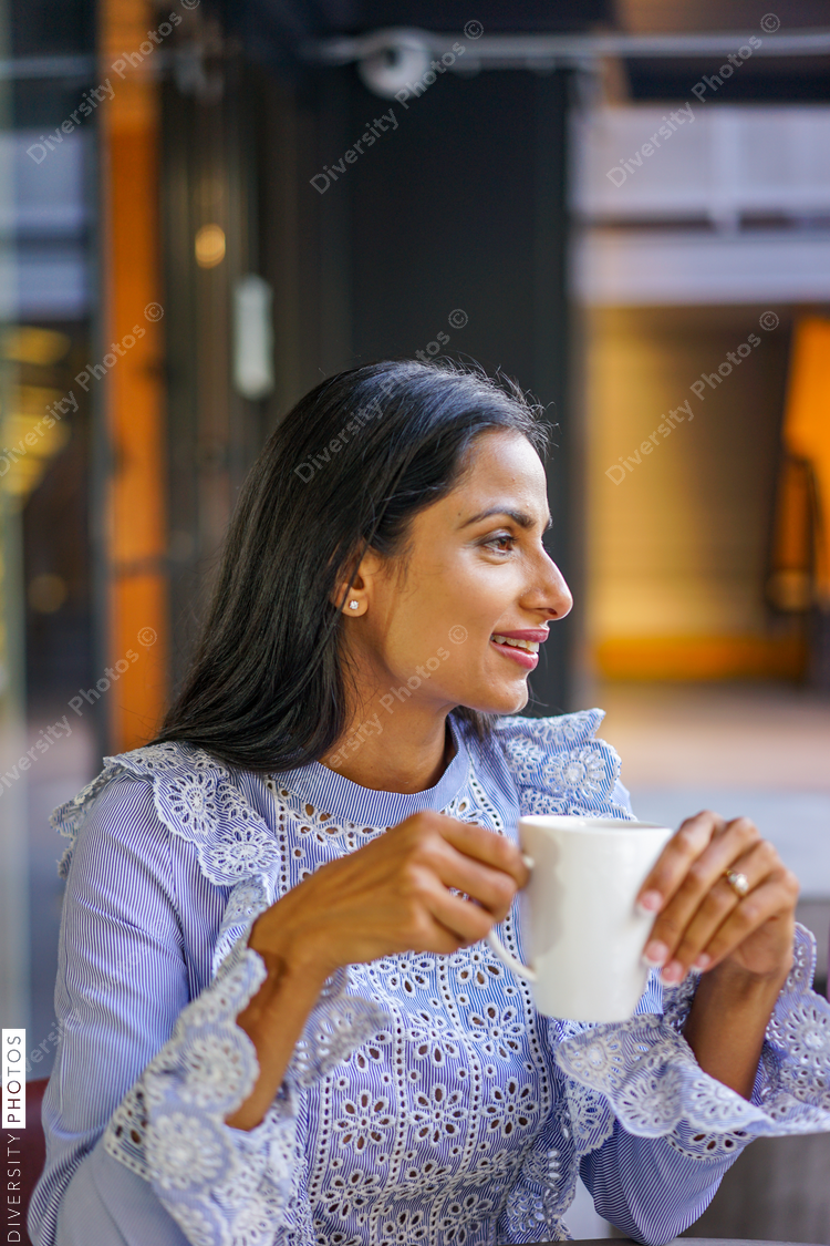 Close up of a smiling woman at coffee shop