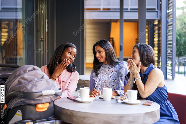 Smiling female friends at coffee shop