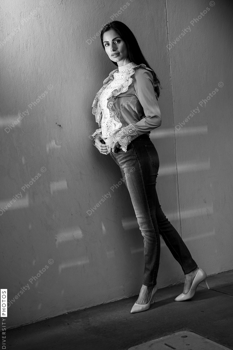 Portrait of woman posing against wall
