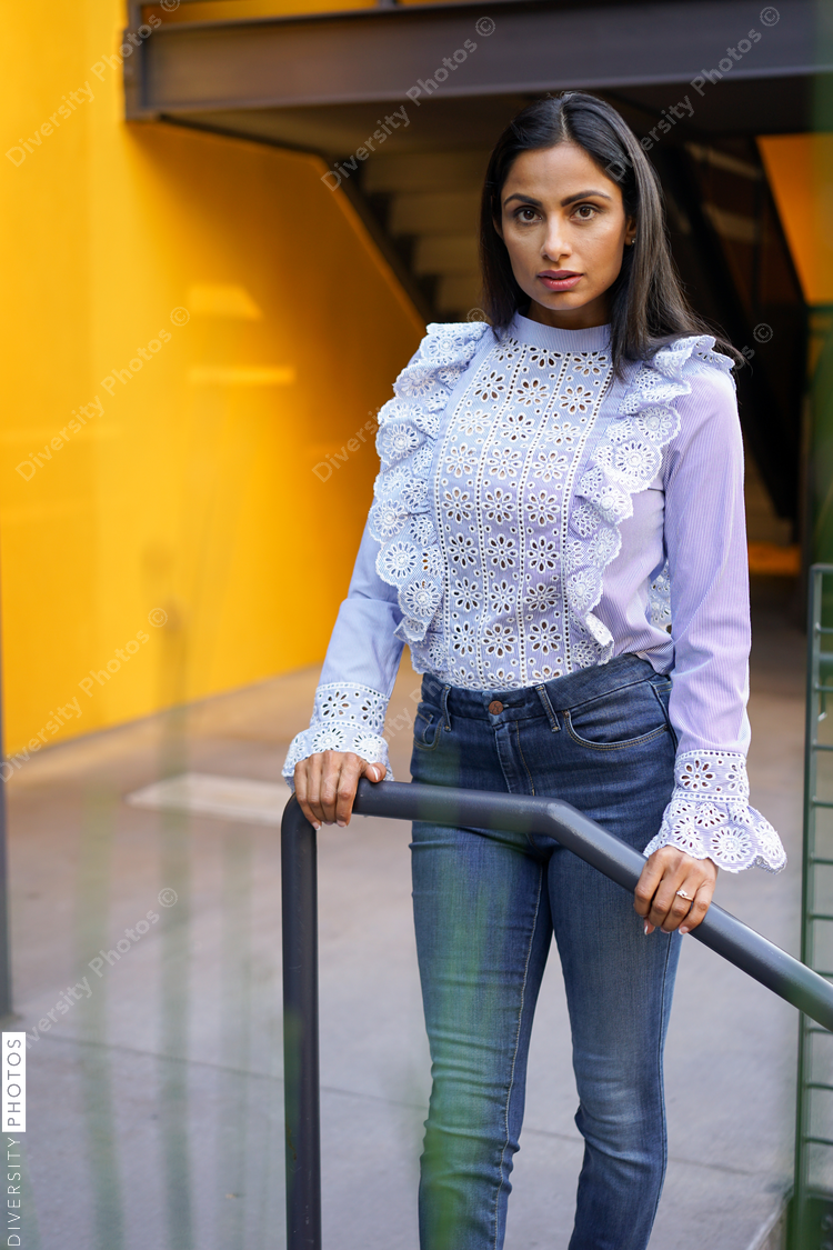 Portrait of woman standing near railings