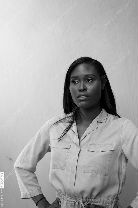 Young woman standing against wall