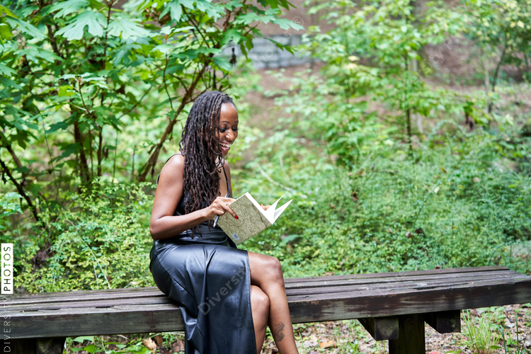 Portrait of Black woman reading and journaling