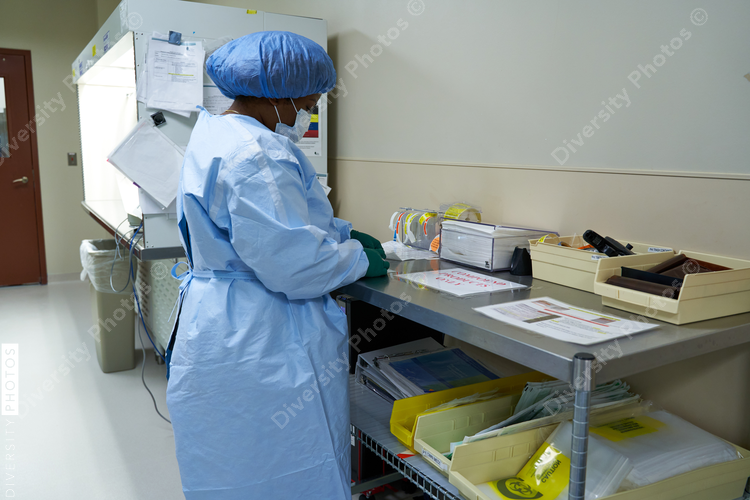 Black healthcare worker pharmacist preparing medicine