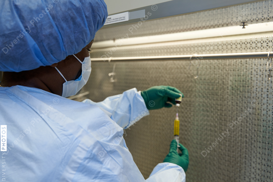 Black healthcare worker pharmacist preparing medicine