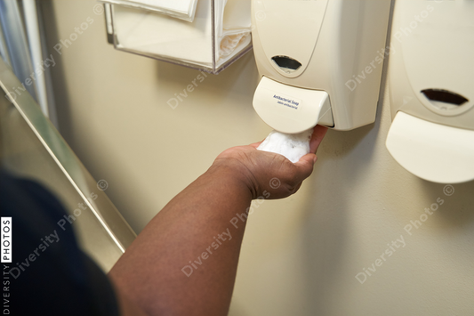 Black healthcare worker washing hands