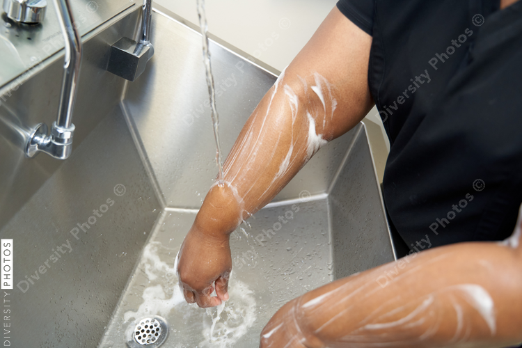Black healthcare worker washing hands