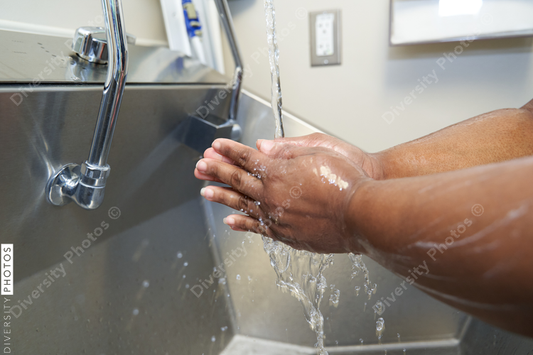 Black healthcare worker washing hands