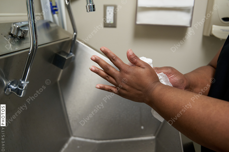 Black healthcare worker washing hands