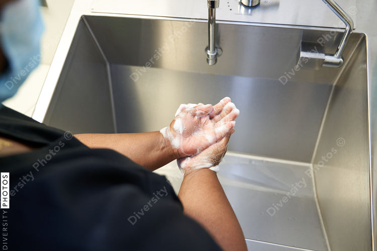 Black healthcare worker washing hands