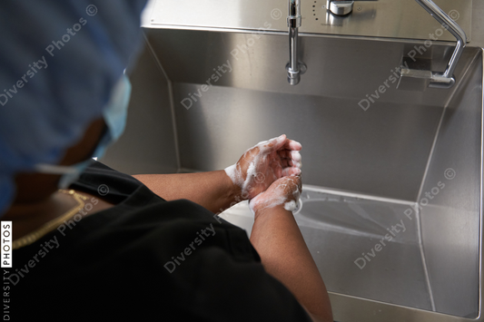 Black healthcare worker washing hands