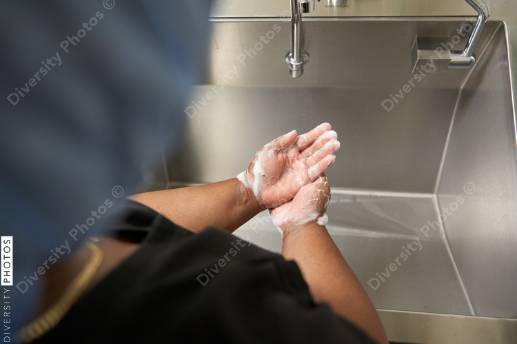 Black healthcare worker washing hands