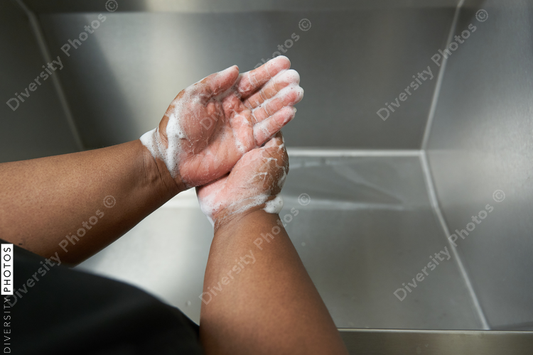 Black healthcare worker washing hands