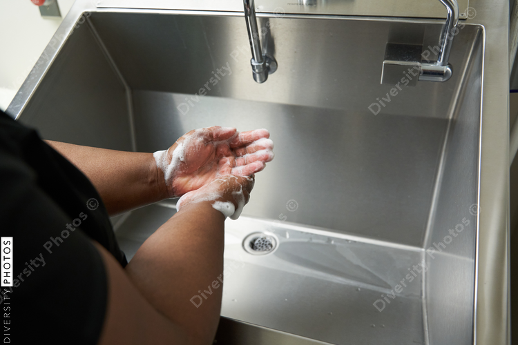Black healthcare worker washing hands
