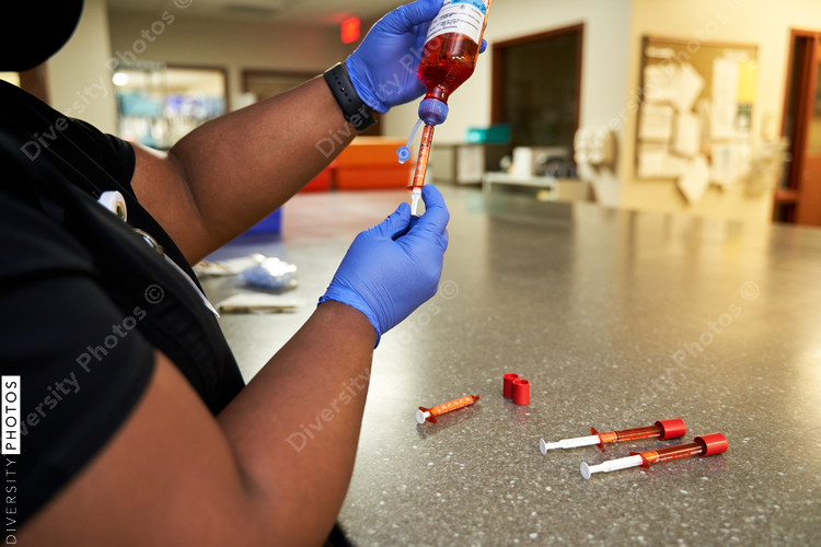 Black pharmacist prepare medication for hospital patient