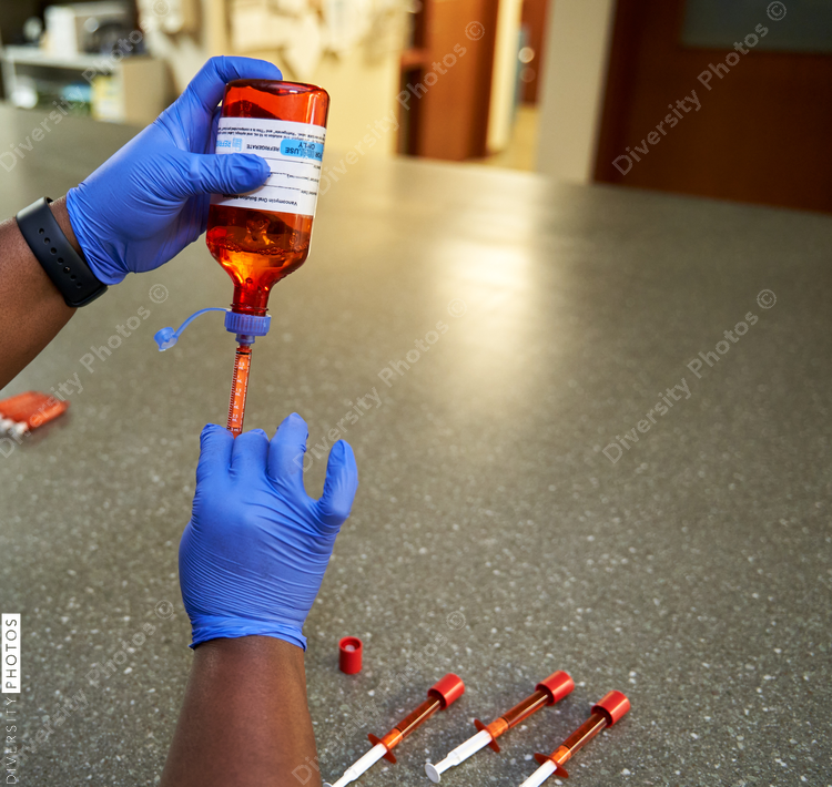 Black pharmacist prepare medication for hospital patient