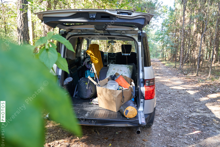 Camping gear being unloaded from vehicle