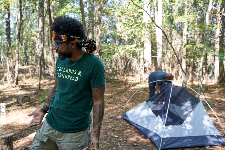 Black man setting up camping tent