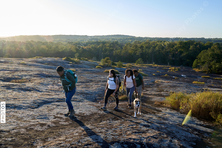 Diverse group of friends hiking Arabia Mountain in USA