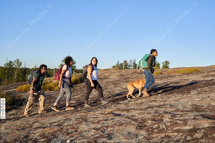 Diverse group of friends hiking Arabia Mountain in USA