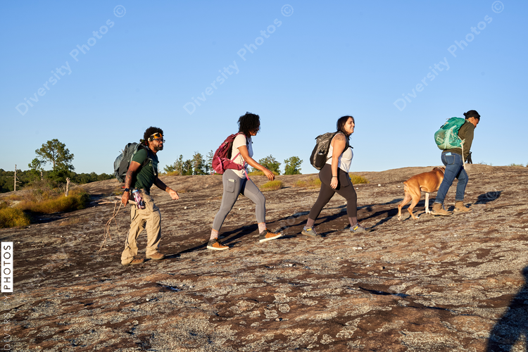 Diverse group of friends hiking Arabia Mountain in USA