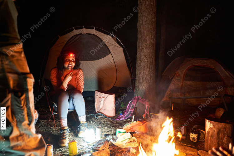 Friends sitting around campfire at night