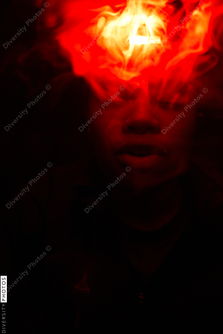 Woman blowing smoke wearing red light