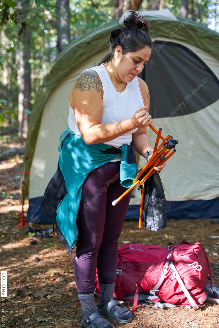 Woman packing up site after camping trip