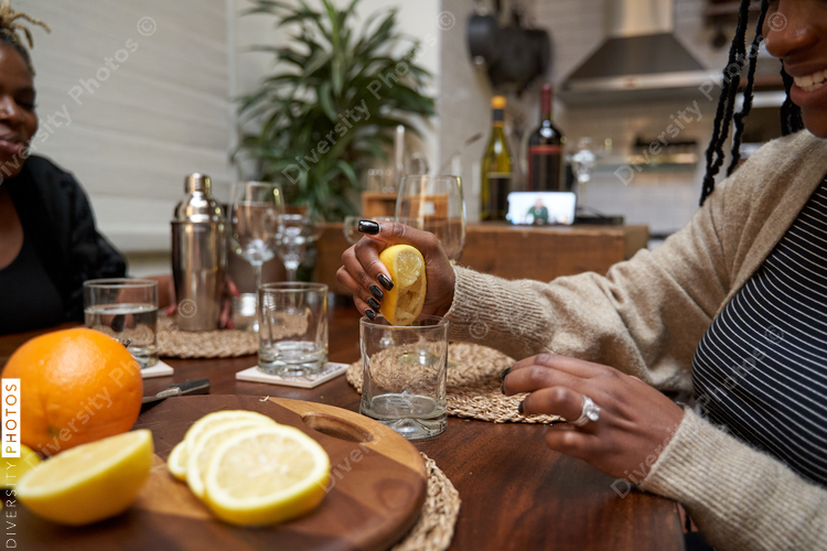 Black women creating DIY cocktails, friendship connections