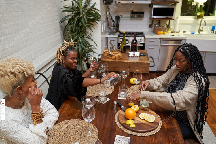 Black women creating DIY cocktails, friendship connections