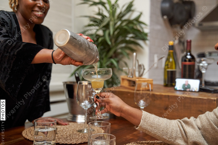 African American women creating DIY cocktails, friendship connections during self care retreat