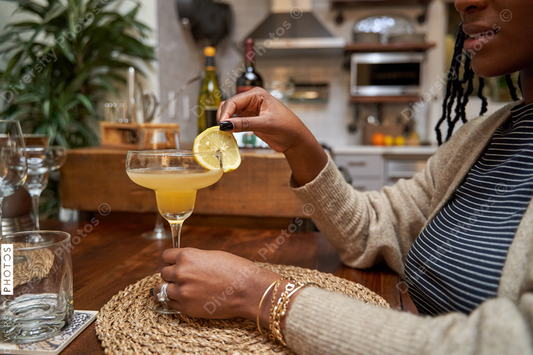 Black female hands and homemade cocktail drink