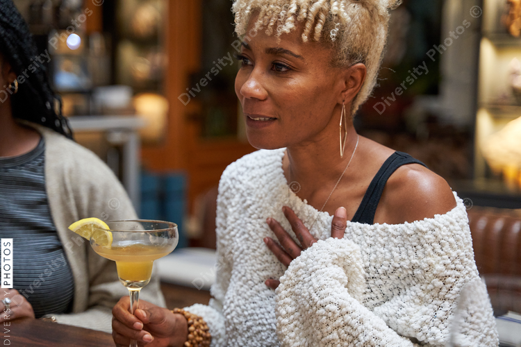 Black girlfriends talking at home during cozy self care retreat